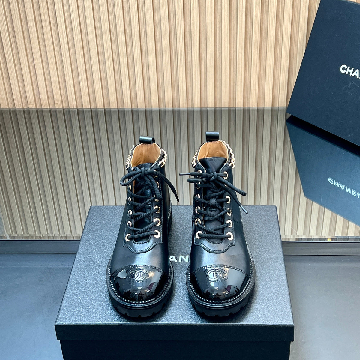 CHANEL 25S MARTIN LACE-UP BOOTS WITH CHAIN DETAIL IN BLACK CALFSKIN